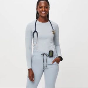 Dusty blue FIGS salta under scrub